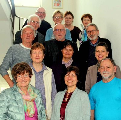 Mehrere erwachsene Personen stehen auf einer Treppe